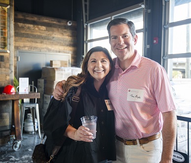 Smiling couple with red hard hat in the background